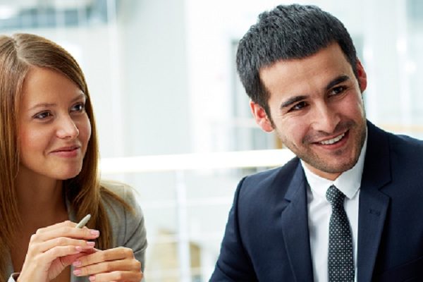 woman and man smiling at someone