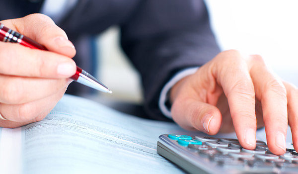 someone using a calculator with a pen in hand