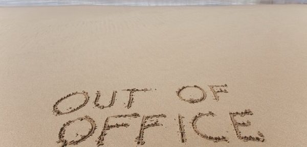 out of office written in sand