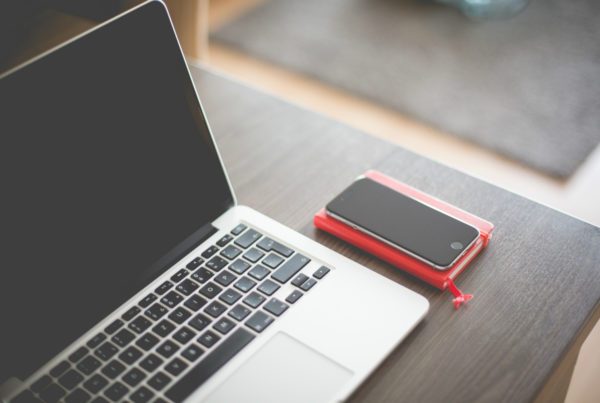 laptop and a phone on a desk