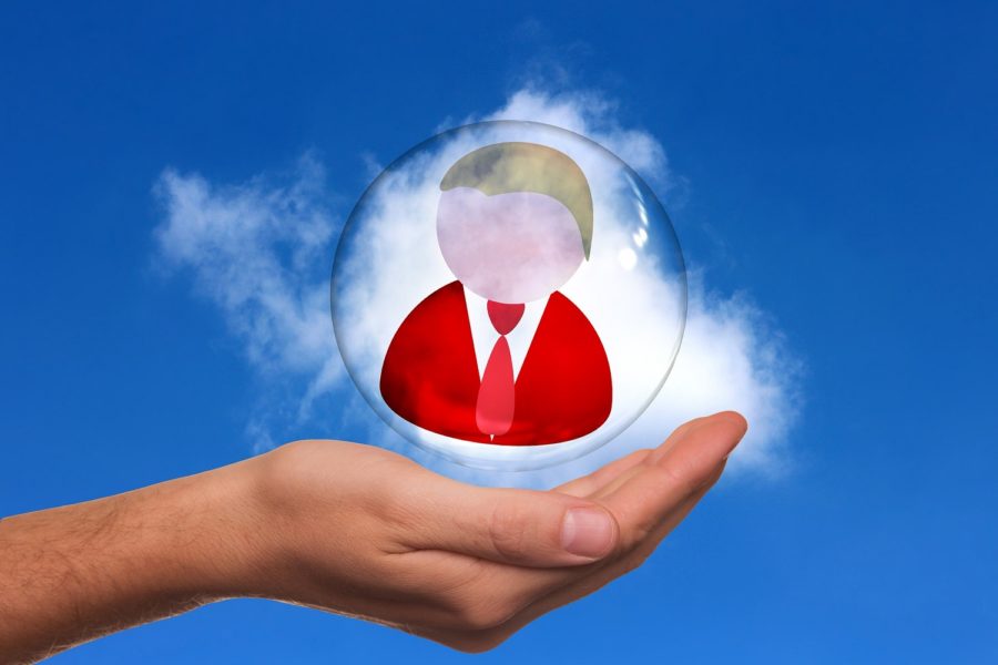 man figure in a bubble with a hand cupping it