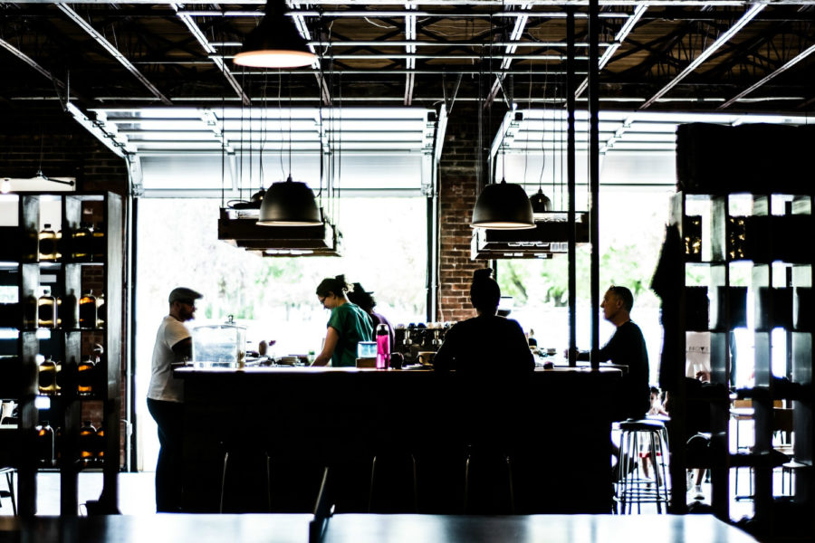 modern cafe with people sat on tall bar stools