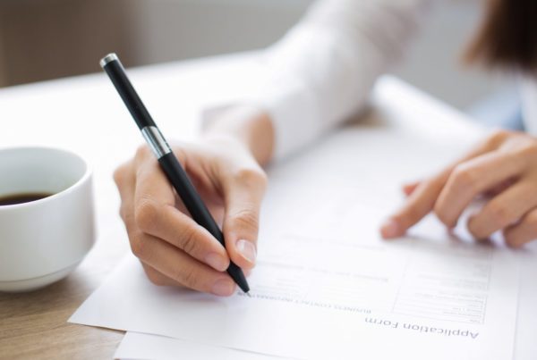 person filling out an application form