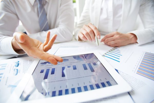 2 people presenting annual reports