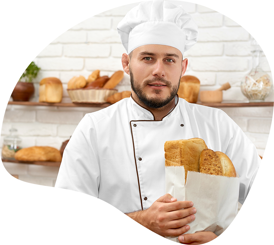 baker with loafs of bread in his hand in a bag
