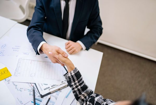 business woman and man shaking hands
