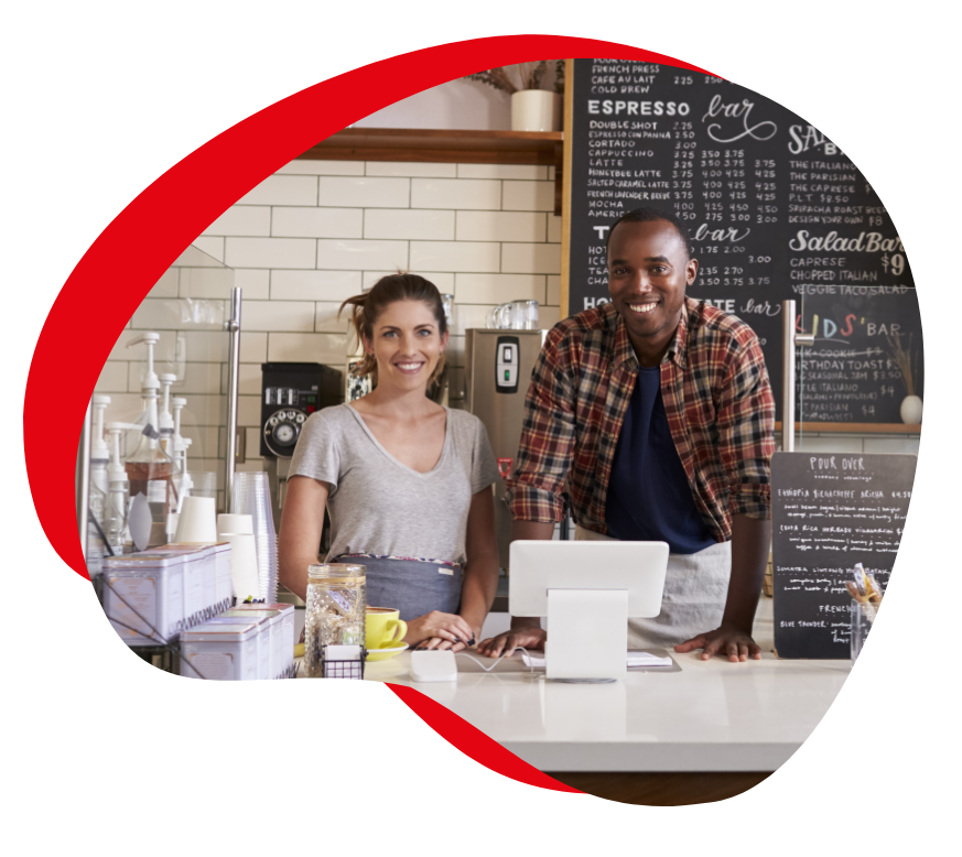 "Small business owners standing in their coffee shop"